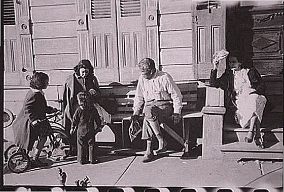 New Orleans Louisiana 1941 porch family scene bicycle children adults FSA